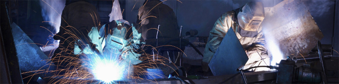 welder working with sparks flying around them